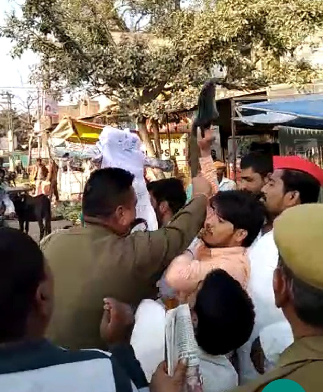 SP workers and police clash over burning effigy of minister