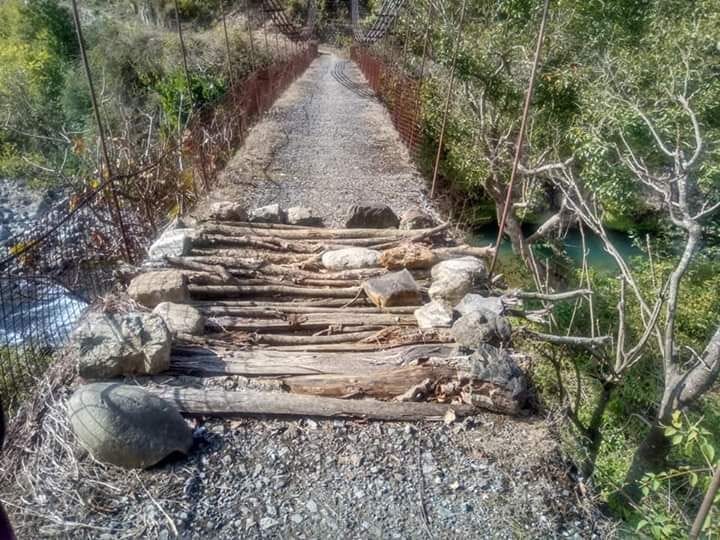 Villagers moving on the suspension bridge at risk