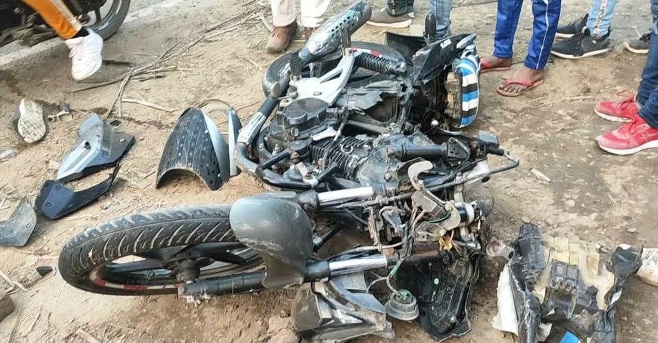 Two youth riding a bike after being crushed by a truck