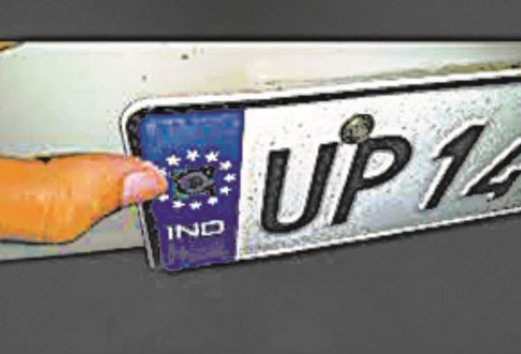 high security number plate being put on in old vehicles