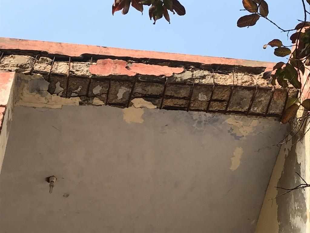 Military board office running in dilapidated building, part of the letter has fallen