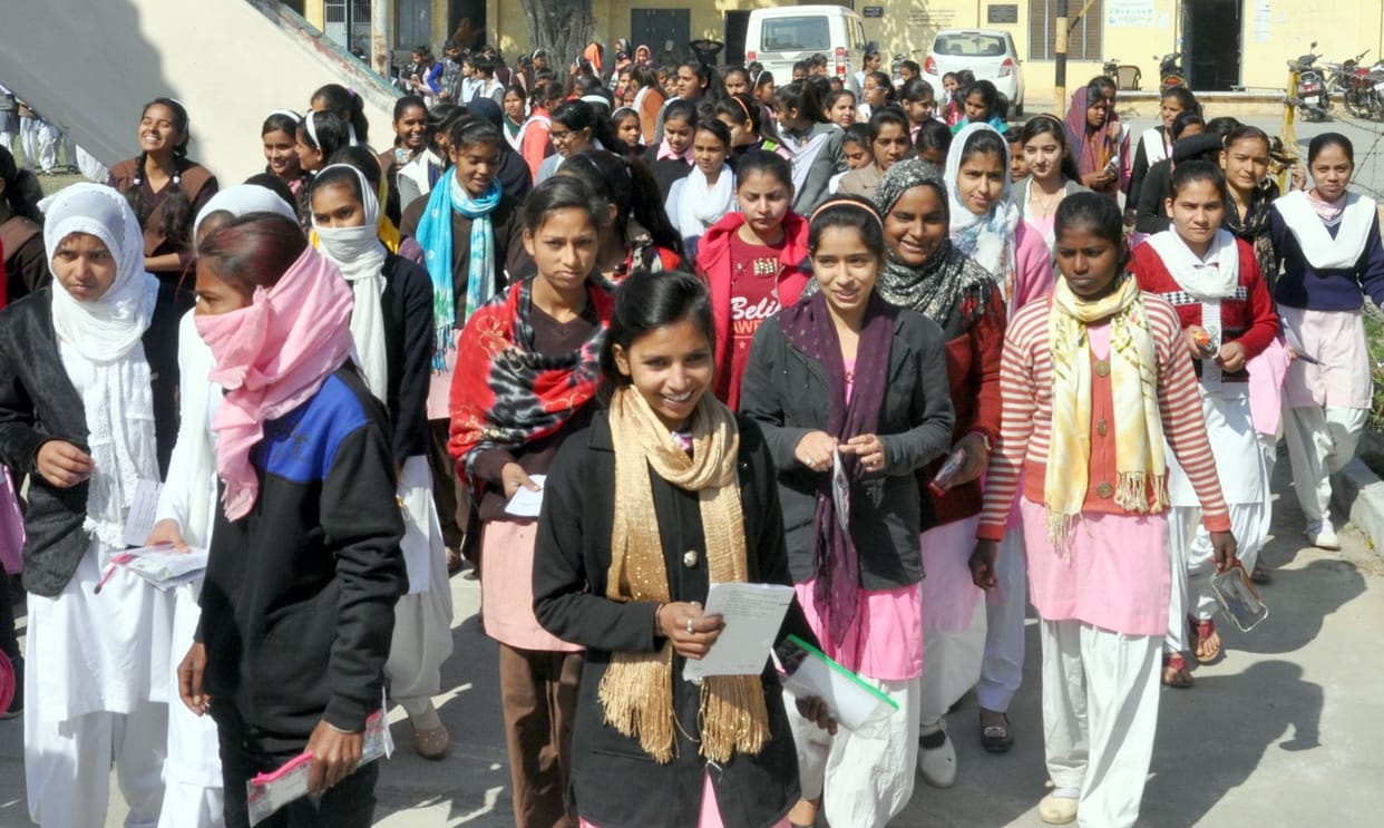 Students looking at the question paper in Hindi
