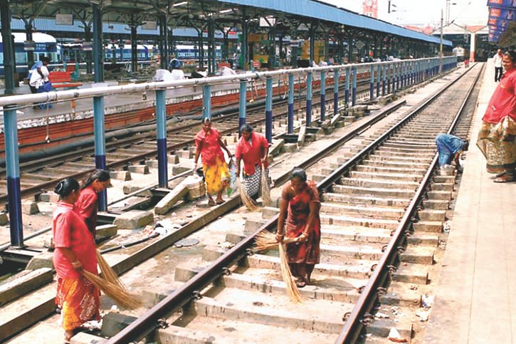 Pit on railway station platform, water on foot over bridge