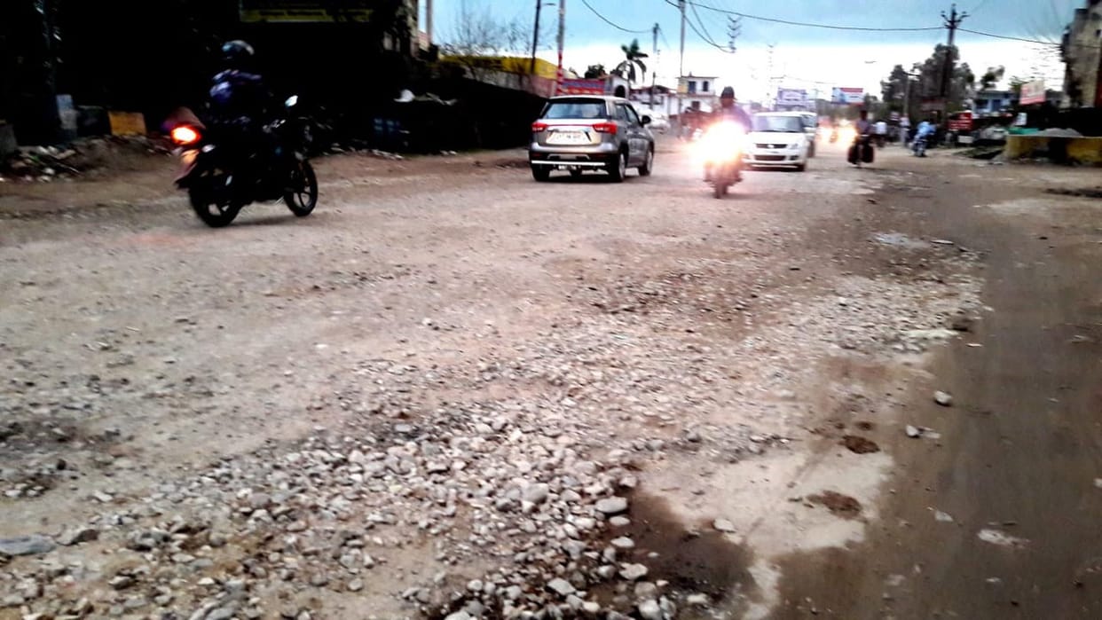 Driver being injured by potholes on Delhi Road