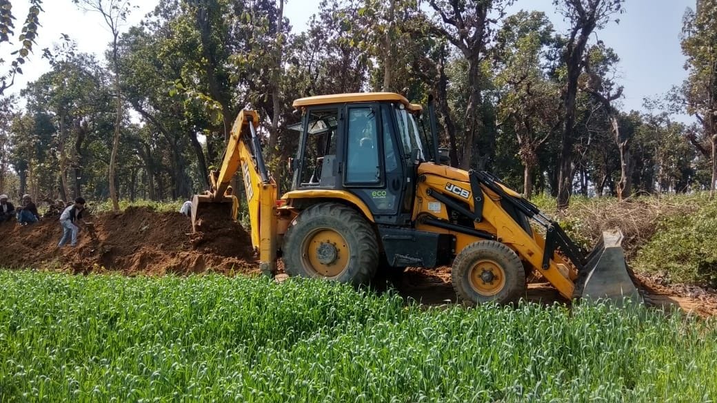 Ditch being dug from JCB in forest area
