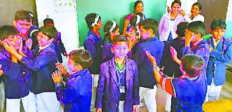 Children played Holi fiercely in school
