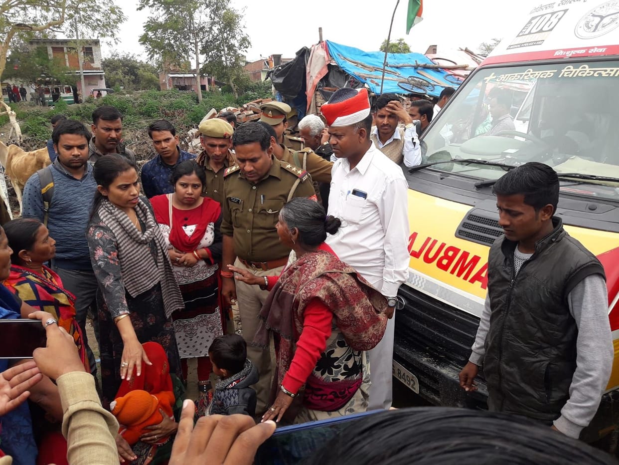 Kin sitting in front of ambulance