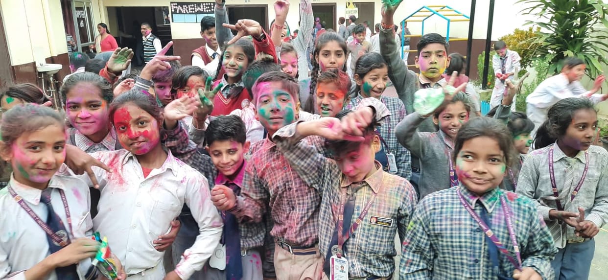 Students dressed in the colors of Holi, said - Happy Holi