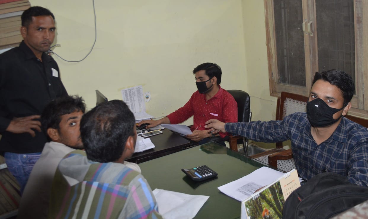 Hathras: Workers wearing masks in government office