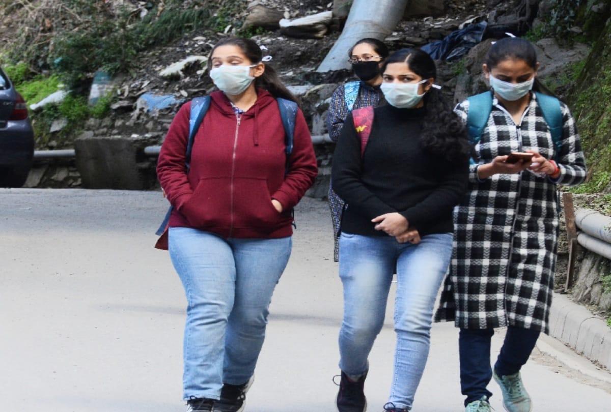 मास्क पहनकर जातीं युवतियां