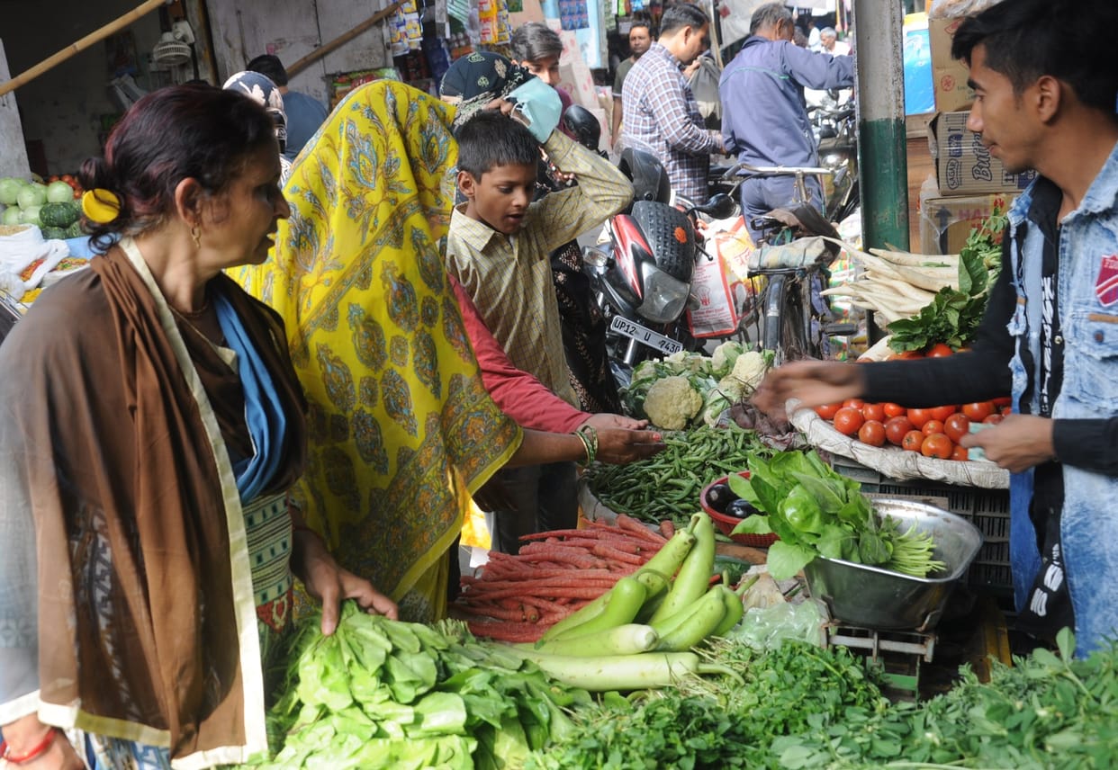 People are busy shopping for vegetables and ration