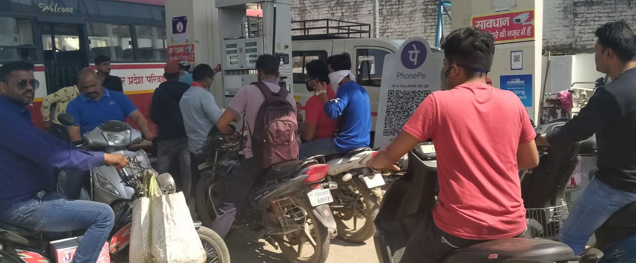 Crowd of oil pickers gathered at petrol pumps