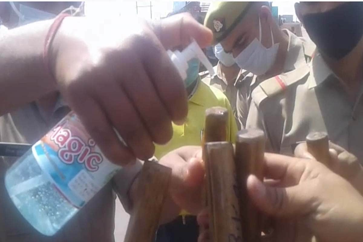 Coronavirus in india: Meerut police sanitizing their sticks for people of rules breaker of the lockdown