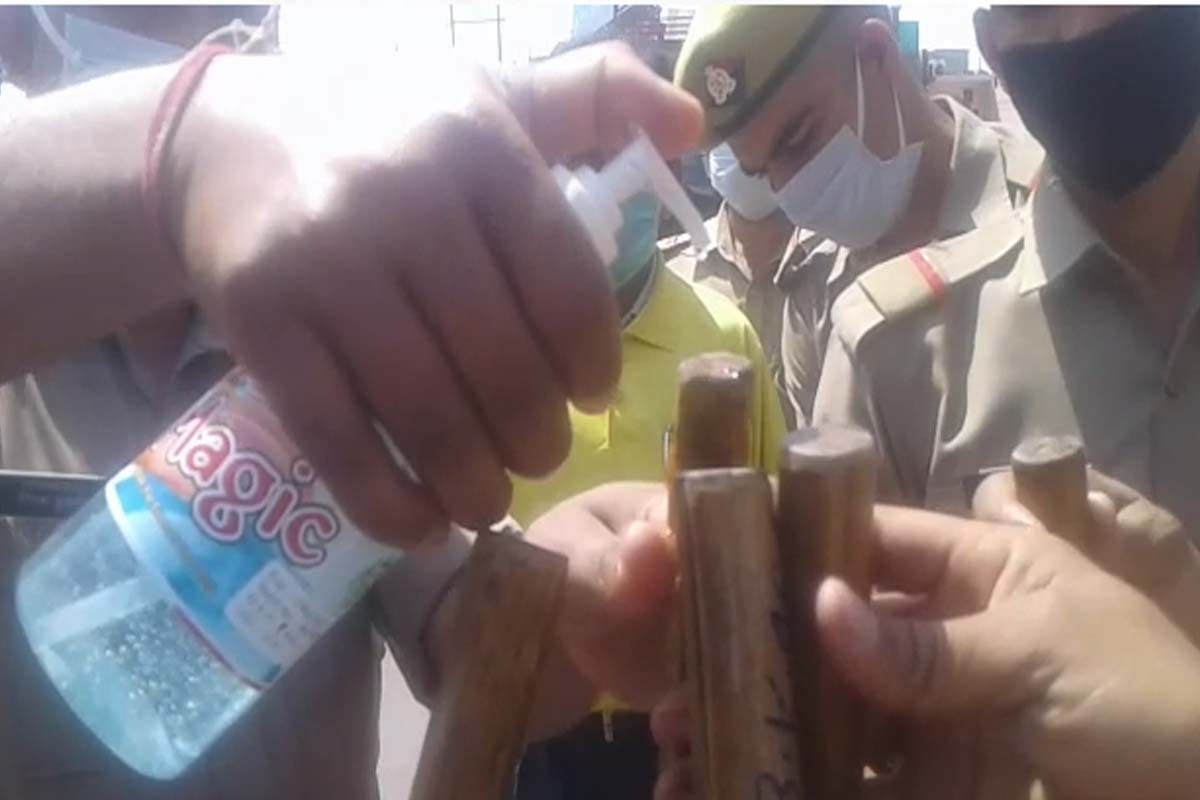 Coronavirus in india: Meerut police sanitizing their sticks for people of rules breaker of the lockdown