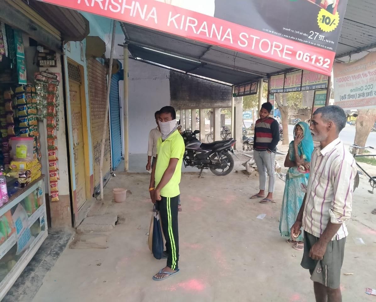 Customers buy goods standing at a distance of six feet