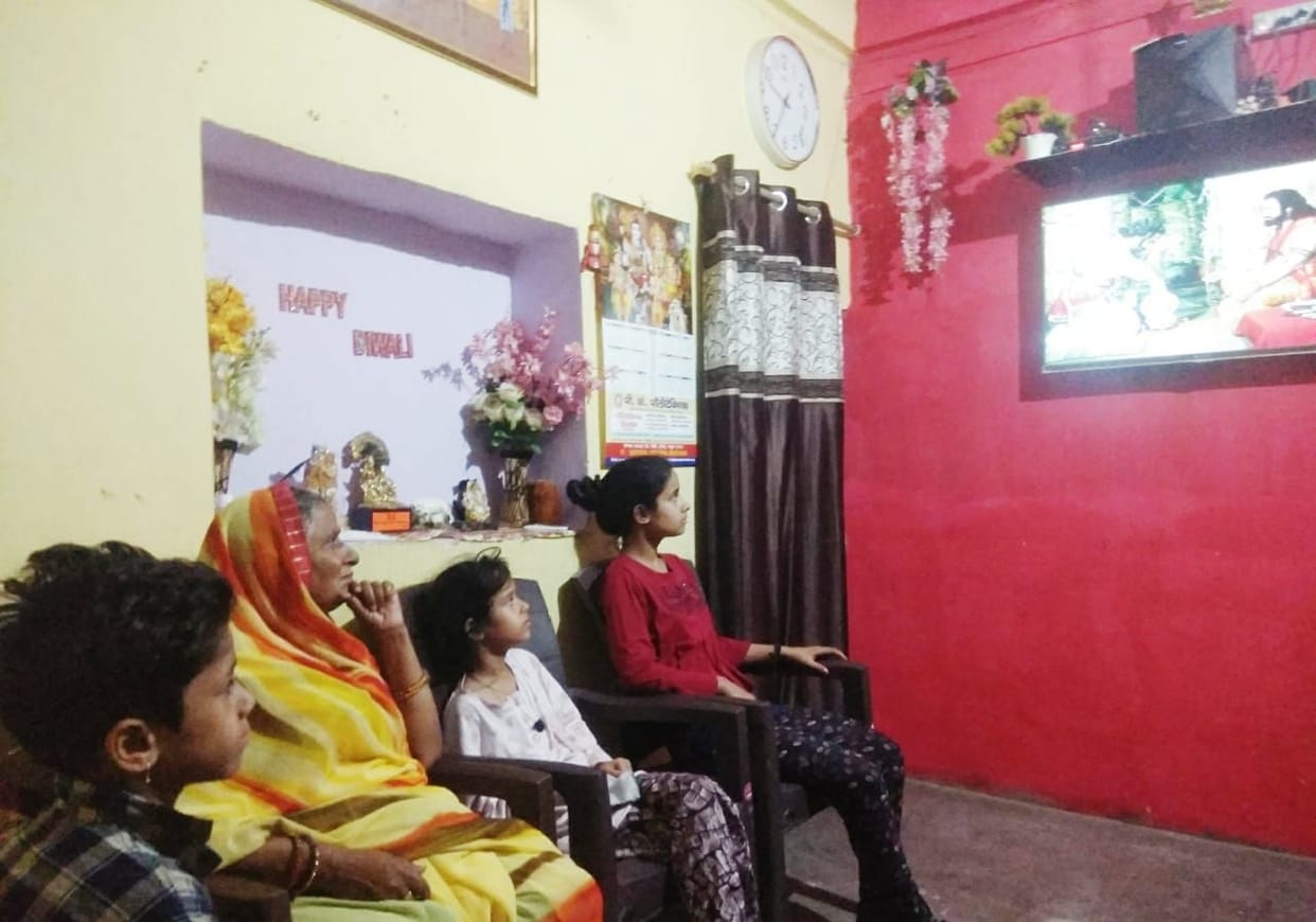 people are playing ludo and watching tv with family