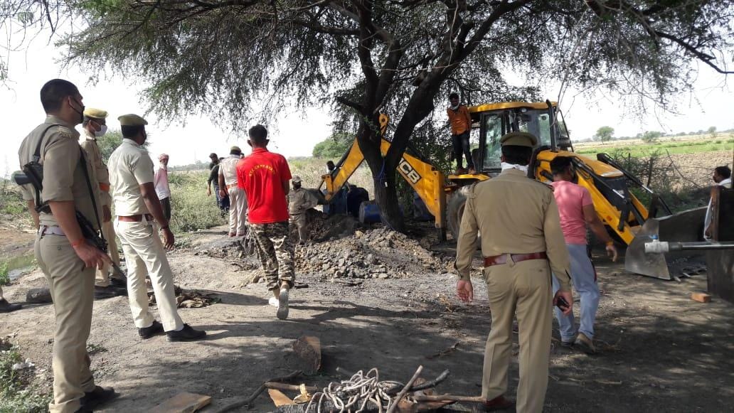 Illegal liquor extracted by digging land from JCB
