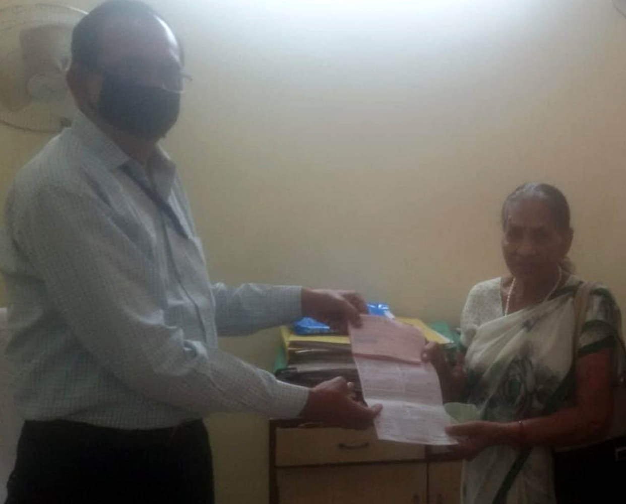 Donated check handed over to bank manager after wandering for a week