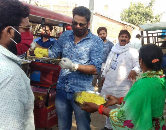Food being fed to poor and cattle including monkey in Chitrakoot