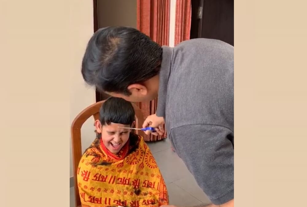 UP government minister Satish Chandra Dwivedi becomes hair dresser for his son.