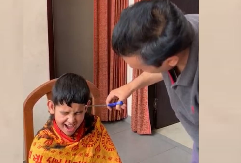 UP government minister Satish Chandra Dwivedi becomes hair dresser for his son.