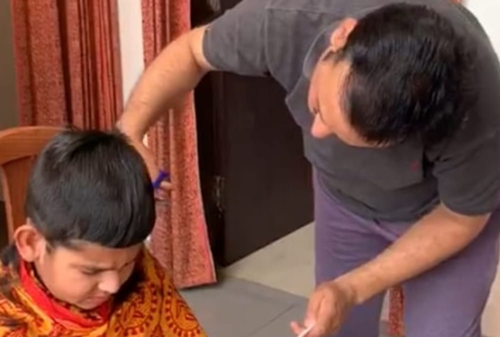 UP government minister Satish Chandra Dwivedi becomes hair dresser for his son.