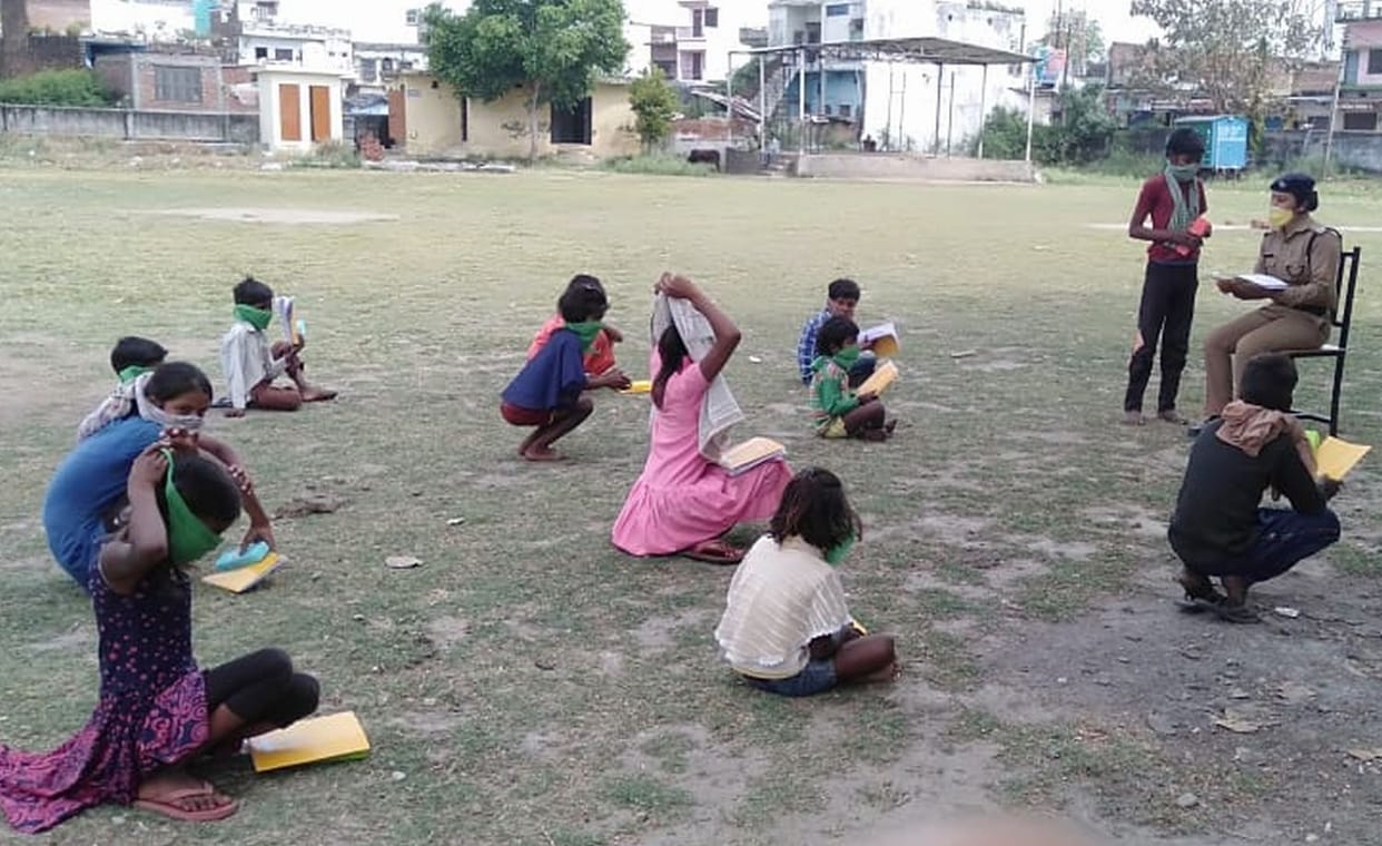 Women police constables teaching children with duty