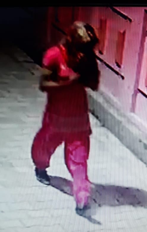 Suspect walking in women's clothes