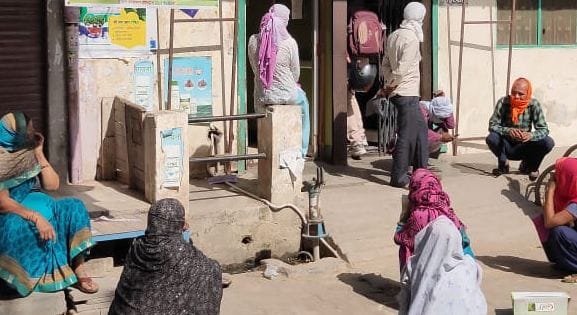 Women sitting on the road to withdraw money from banks