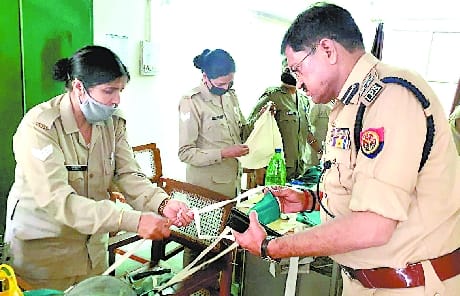 Female soldiers making masks for range office staff and complainants