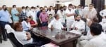 मार्केट कमेटी कार्यालय में सचिव से बातचीत करते व्यापारी।