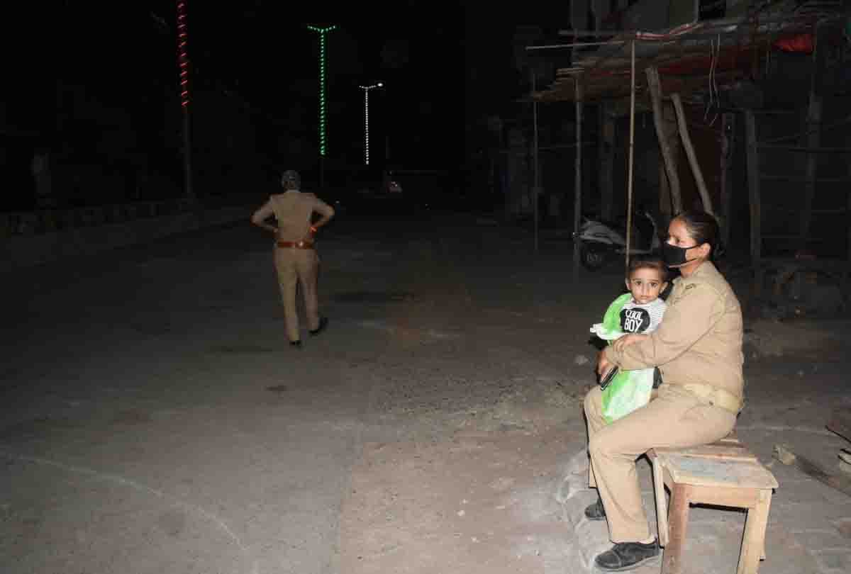 woman constable giving duty in red zone with child in his lap
