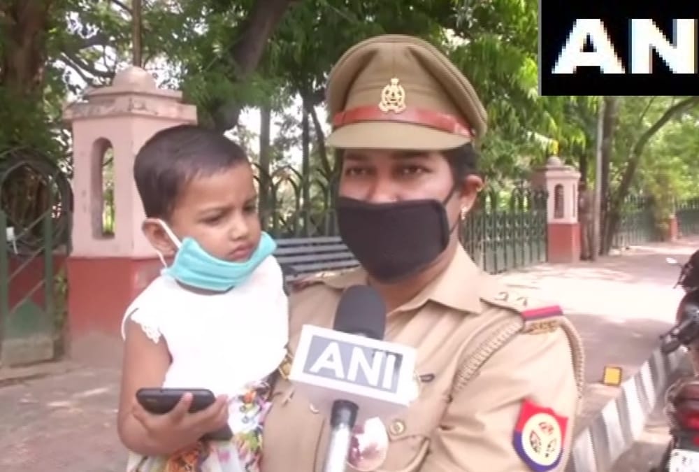 corona warriors: A police woman come for duty with her daughter.