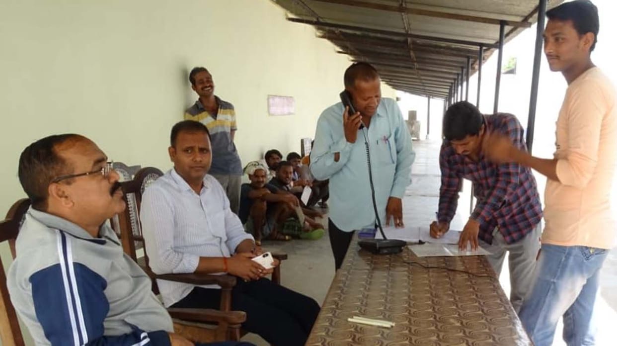 Detainees talk on the telephone with family