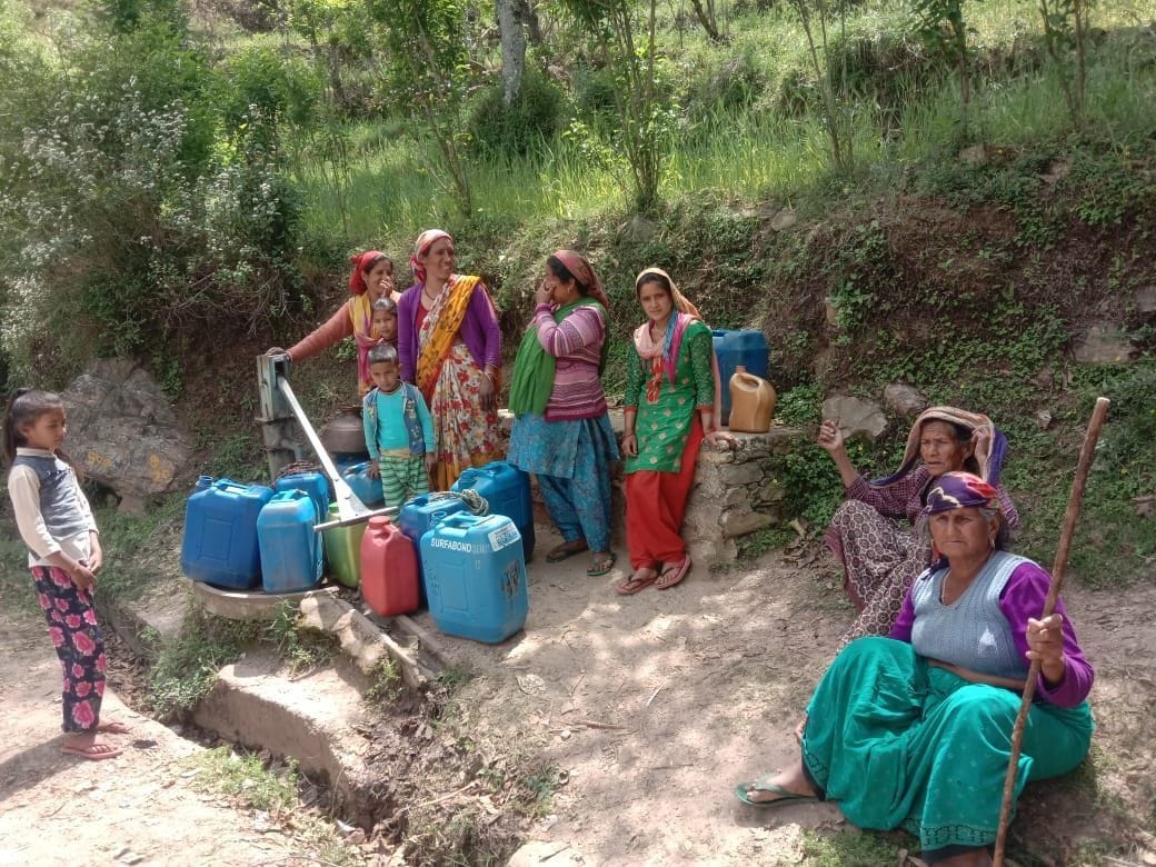 Villagers collecting water from remote hand pumps