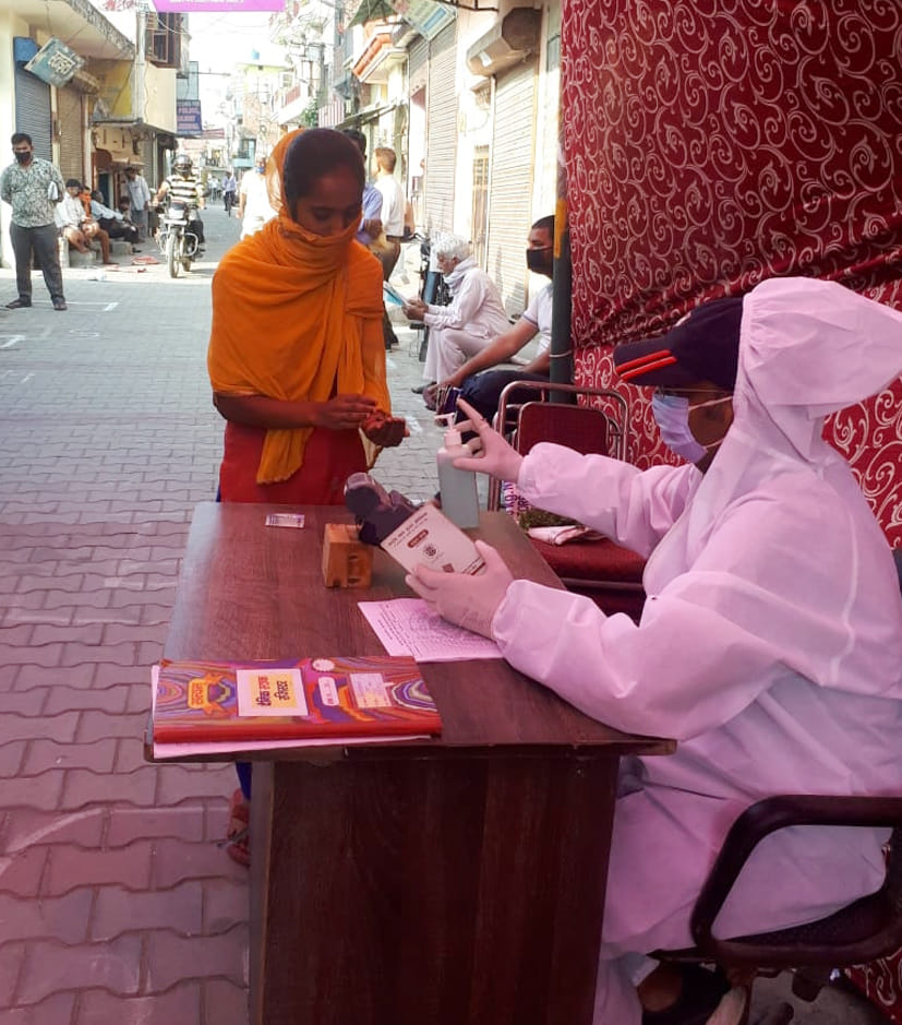 Dealers distributing rations wearing PPE kits