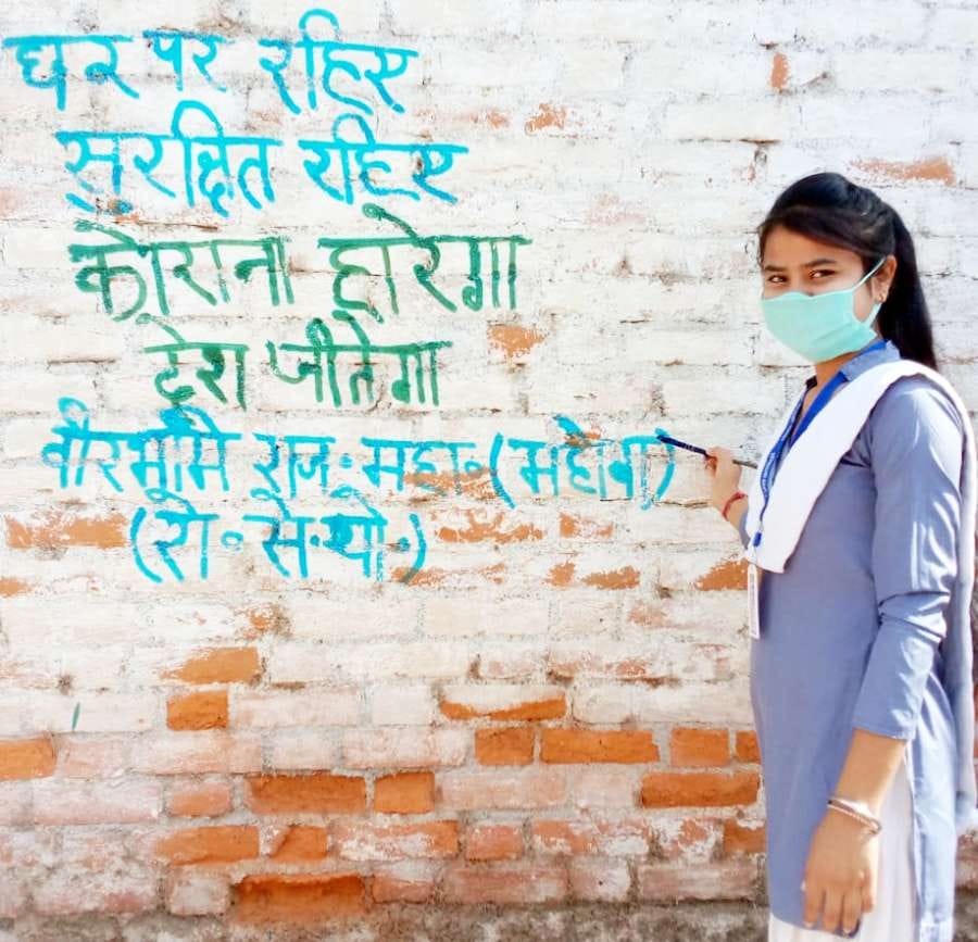 Students are making awareness by writing slogans on the walls