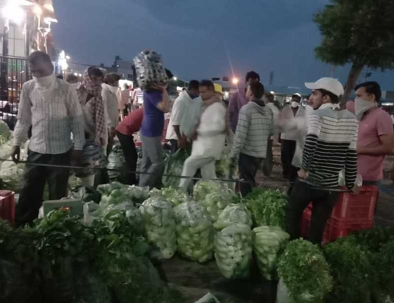 Policemen stationed at gate inside and outside vegetable market, still chaos