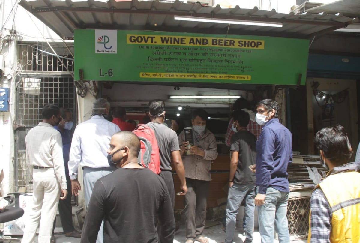 Delhi liquor shop open after one month long queue outside shops social distancing rules broken police lathi charge wine shops shuts