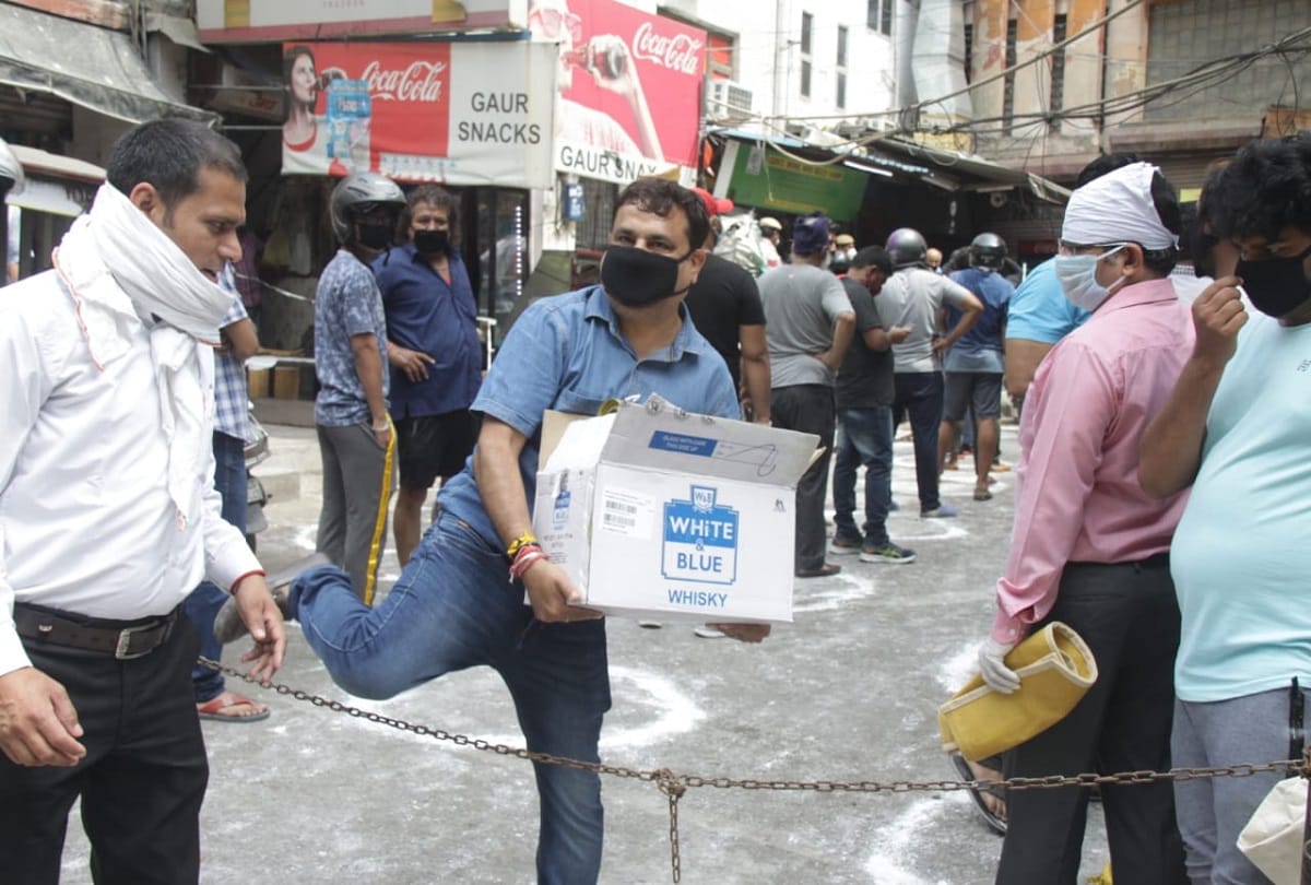 Delhi liquor shop open after one month long queue outside shops social distancing rules broken police lathi charge wine shops shuts