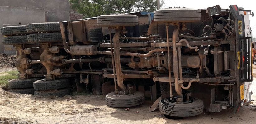 Truck loaded with dust overturns, driver and helper injured