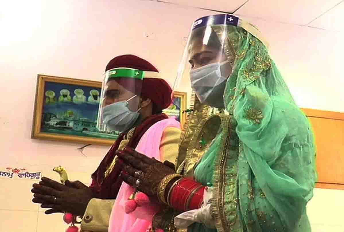 Lockdown: bride and groom wearing face shield and mask during marriage