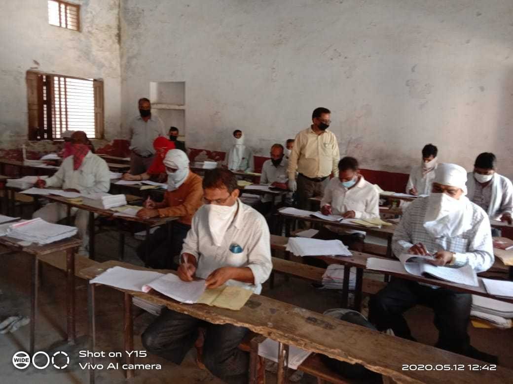 Answer books being checked at three centers