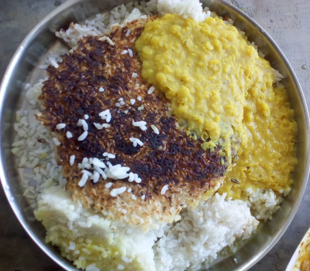 Burnt rice and lentils being fed to quarantine people