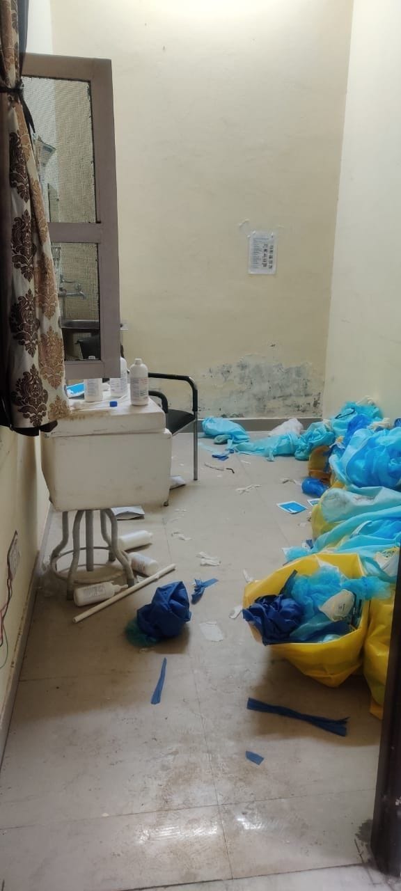 PPE kits are scattered in the doffing-doning area of Covid Hospital
