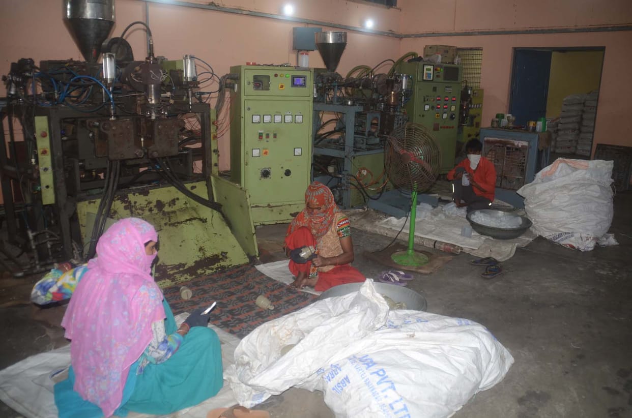 Wheel of factories rotating with laborers of credit