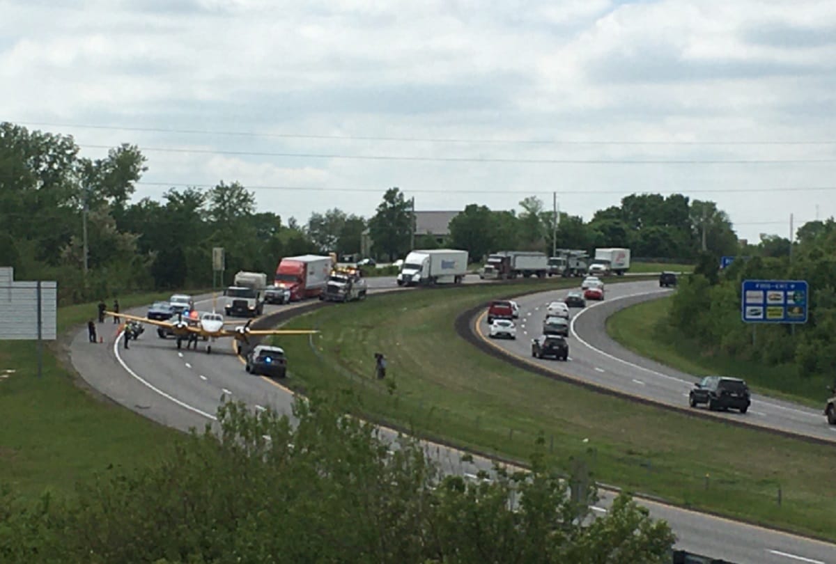 Plane emergency landing between moving cars on highway