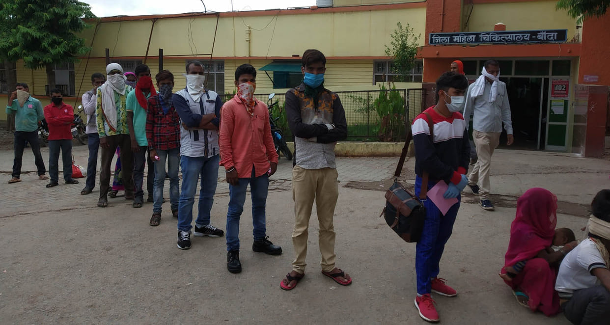 Temperature of workers being measured by poor thermal screening