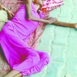 जमीन पर लेटे मां-बेटे (फाइल फोटो)