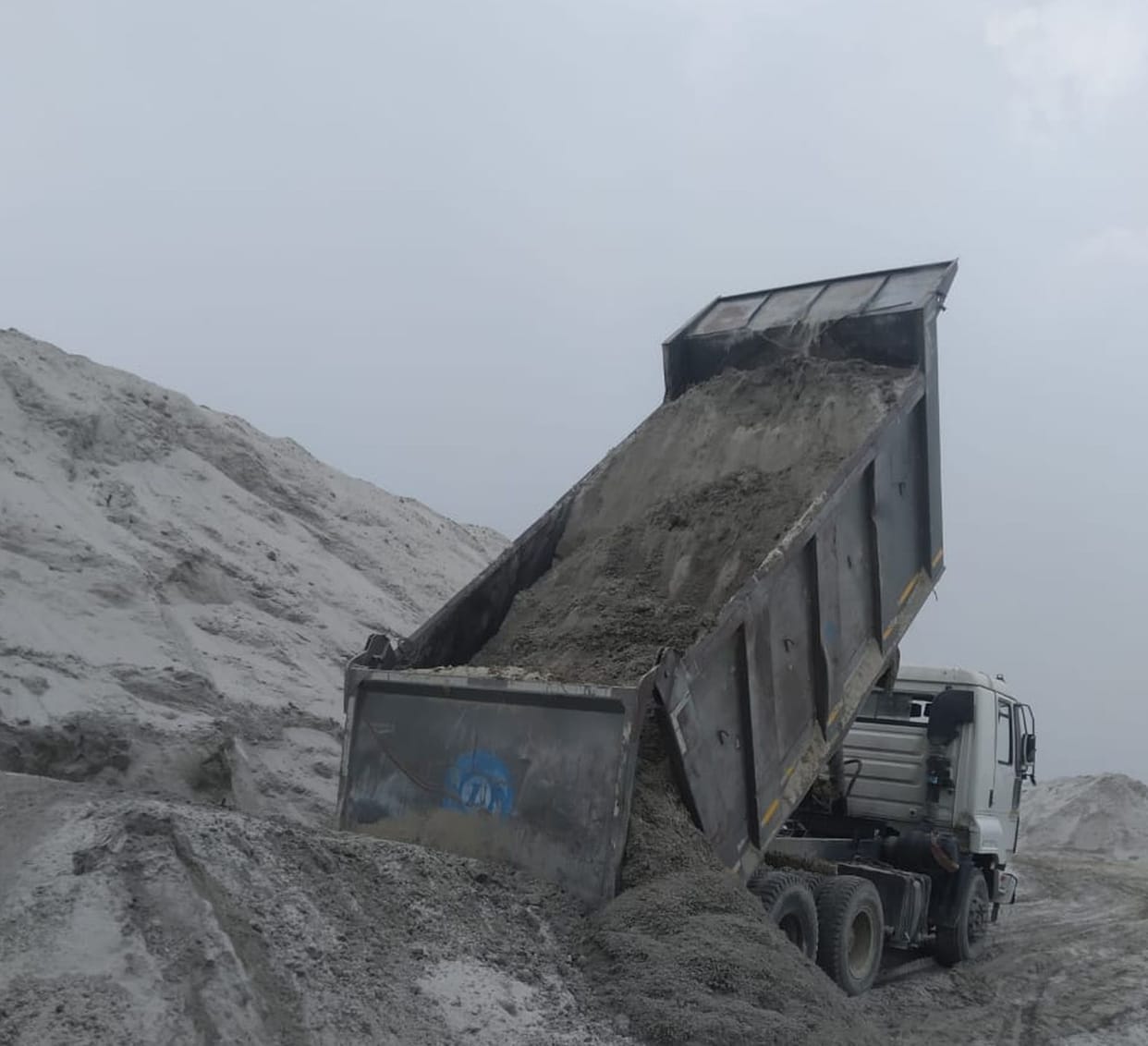 Illegal mining tax trucks dump sand, road construction hung